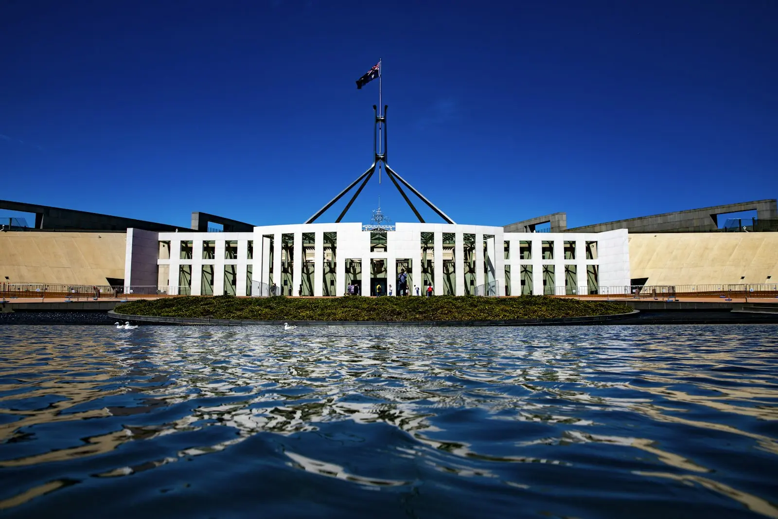 Australian Parliament House in Canberra with the flag flying above it